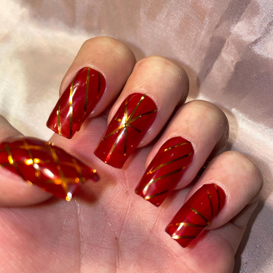 Jelly rouge et rayures doré. Réutilisable, Press-on nails, faux ongles. Finition brillante.