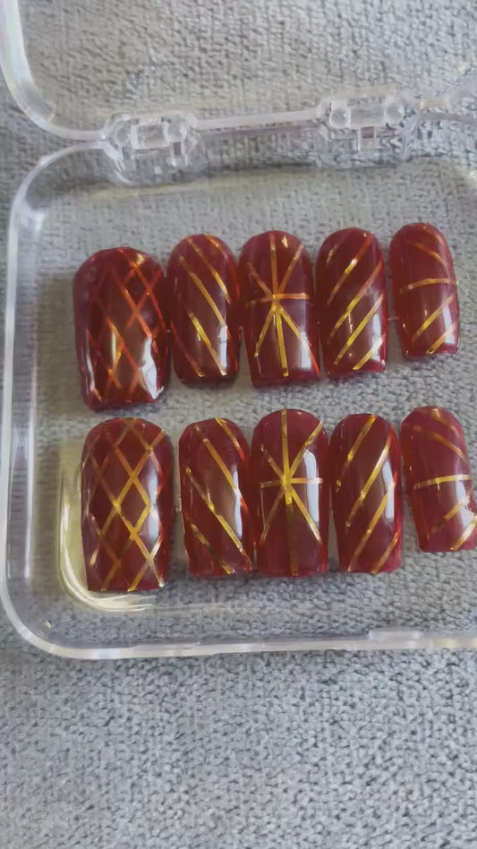 Jelly rouge et rayures doré. Réutilisable, Press-on nails, faux ongles. Finition brillante.