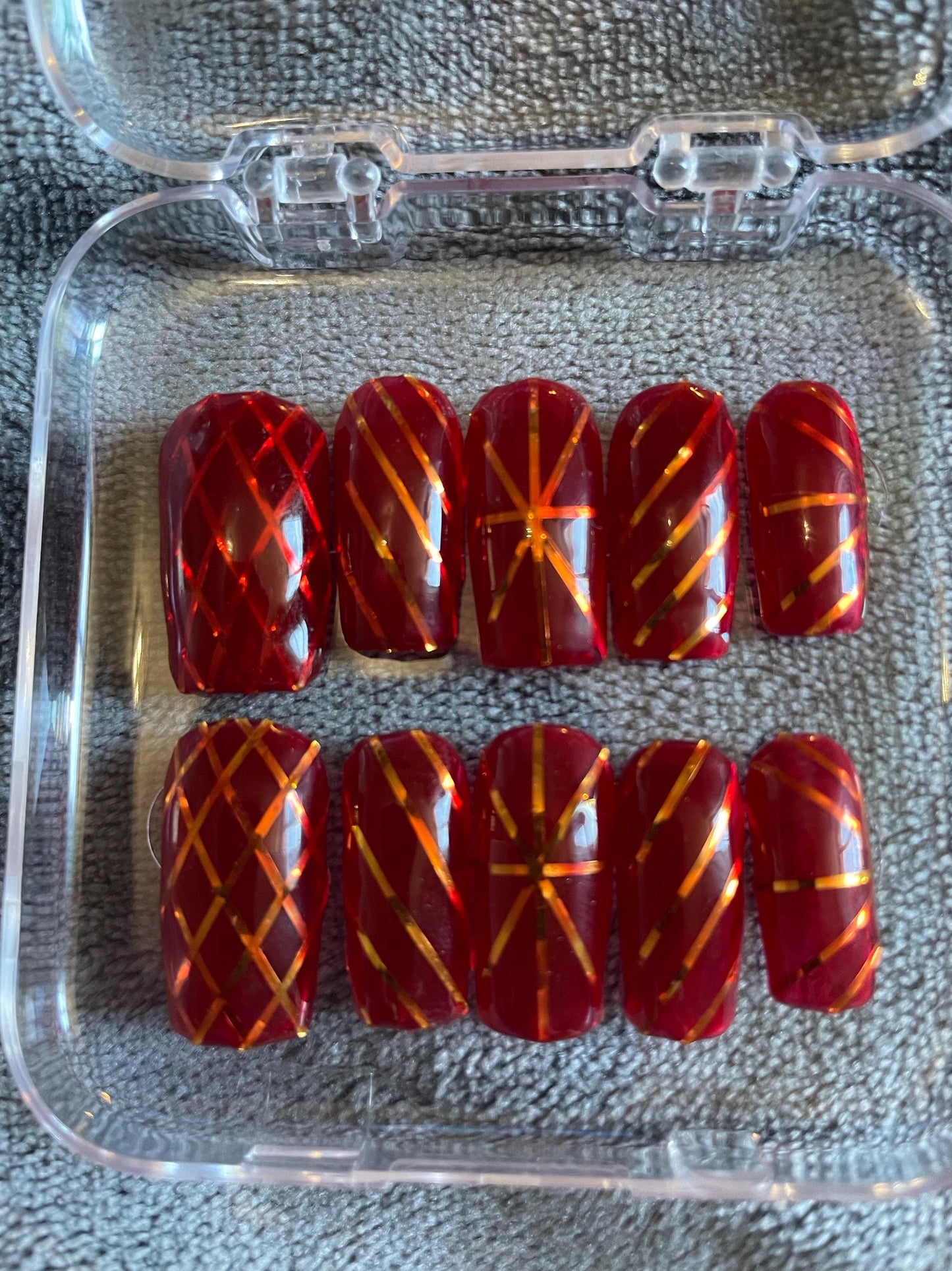 Jelly rouge et rayures doré. Réutilisable, Press-on nails, faux ongles. Finition brillante.