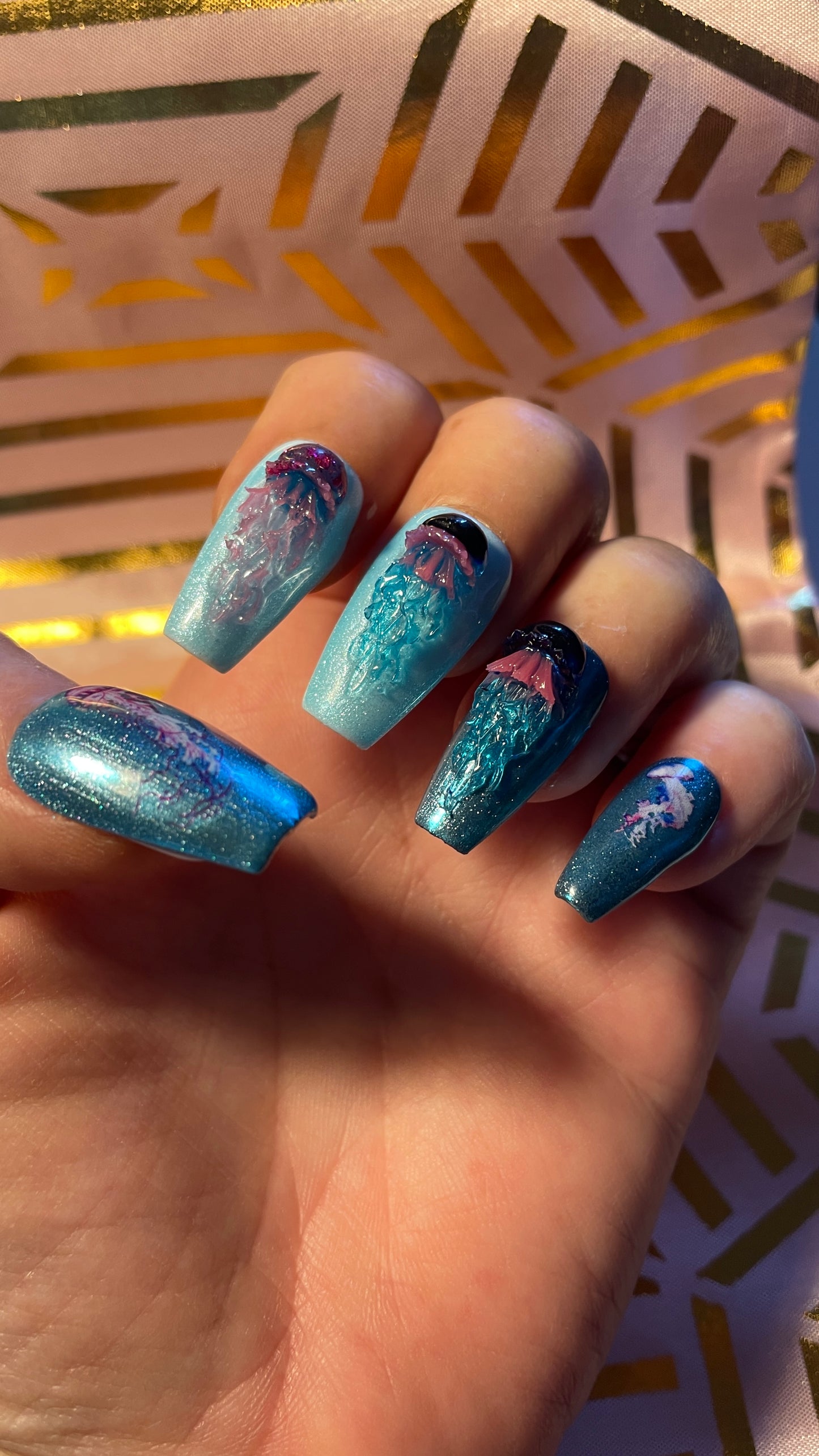 Kit complet. Toutes tailles incluses. Bleu métallisé avec petites méduses en relief. Réutilisables. Press-on nails, faux ongles. Fini brillant